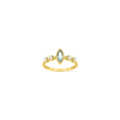 Bague en or jaune et topaze bleue traitée et oxyde de zirconium