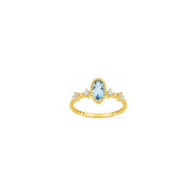 Bague en or jaune et topaze bleue traitée et oxyde de zirconium