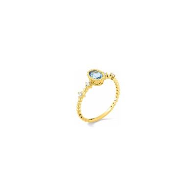 Bague en or jaune et topaze bleue traitée et oxyde de zirconium