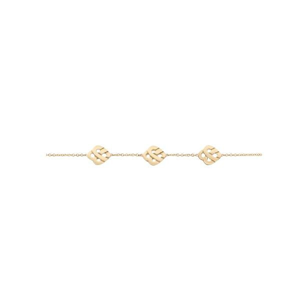 Poiray Coeur Entrelacé yellow gold bracelet with three hearts