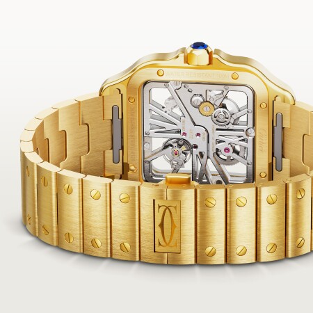 Montre Santos de Cartier Grand modèle, mouvement manuel squeletté, or jaune, bracelets métal et cuir interchangeables