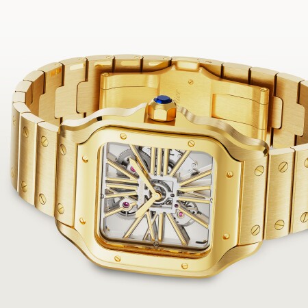 Montre Santos de Cartier Grand modèle, mouvement manuel squeletté, or jaune, bracelets métal et cuir interchangeables