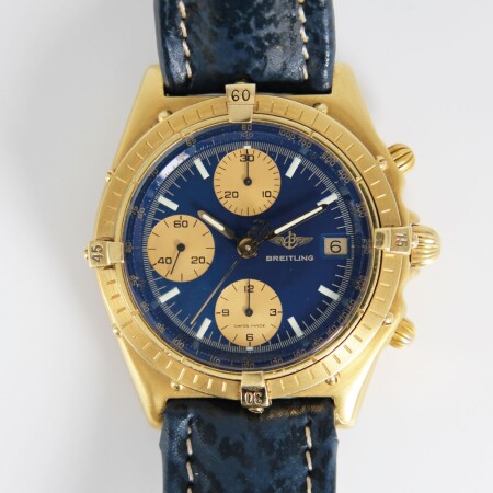 Montre Breitling Chronomat vintage automatique or jaune cadran bleu compteurs dorés bracelet cuir bleu 39mm