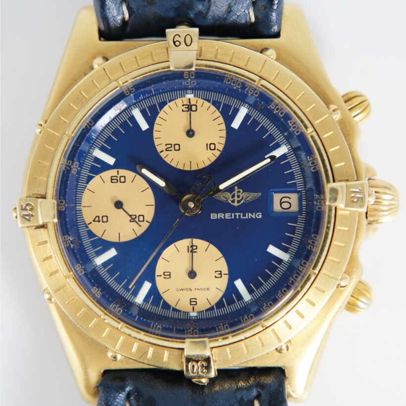 Montre Breitling Chronomat vintage automatique or jaune cadran bleu compteurs dorés bracelet cuir bleu 39mm