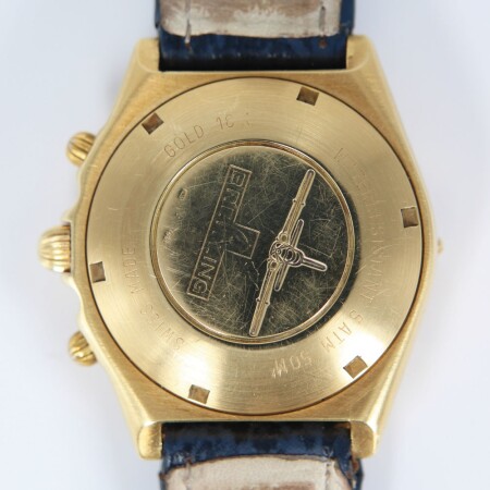 Montre Breitling Chronomat vintage automatique or jaune cadran bleu compteurs dorés bracelet cuir bleu 39mm