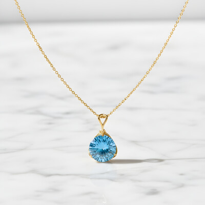 Pendentif or jaune et topaze bleue