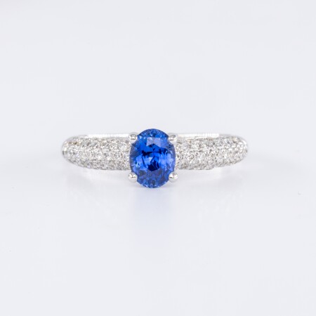 Bague en or blanc centre saphir bleu ovale accompagné de diamants taille brillant