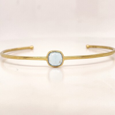 Bracelet jonc en or jaune 750/1000 et topaze bleue